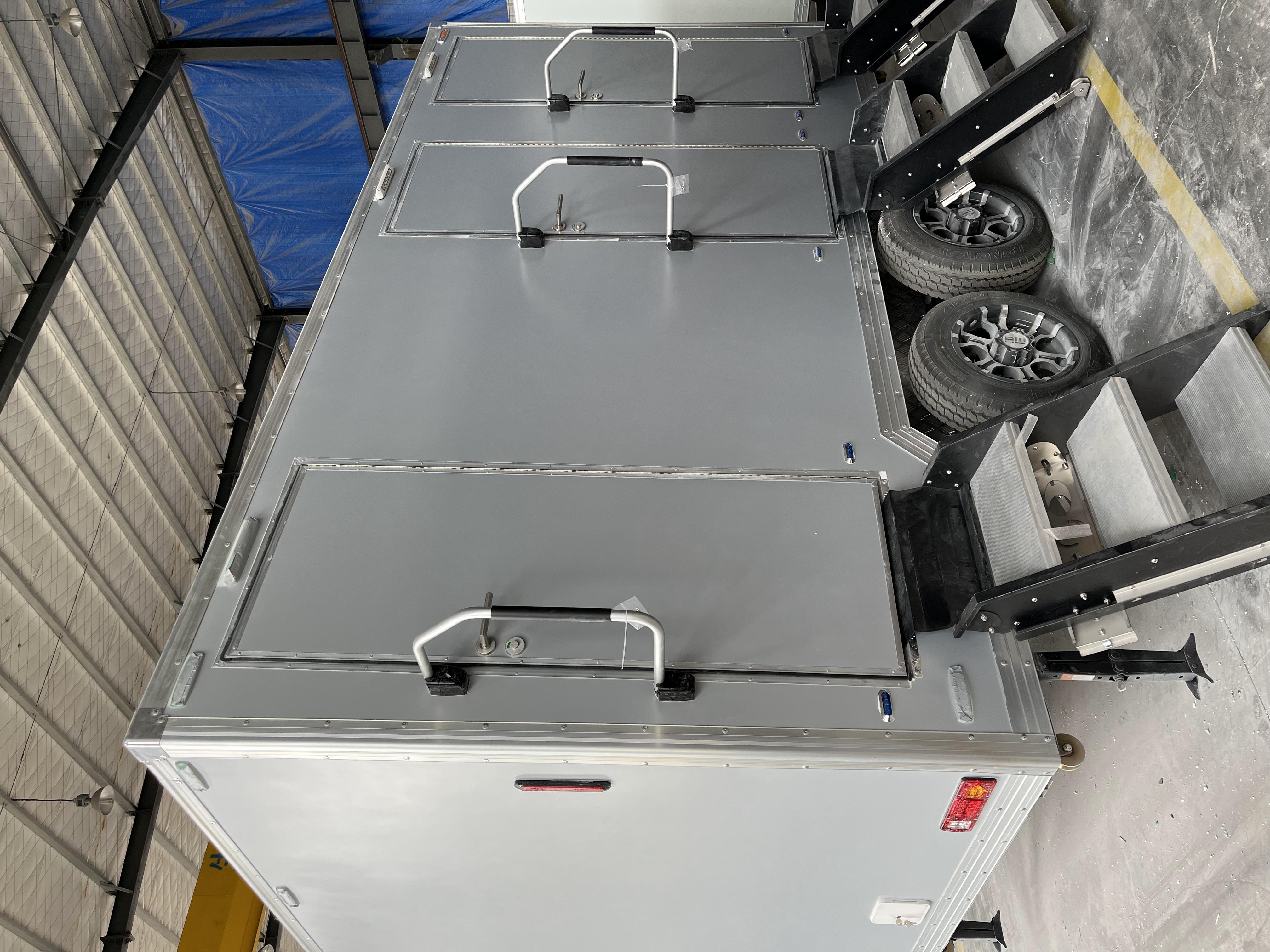 Grey movable three-toilet trailer