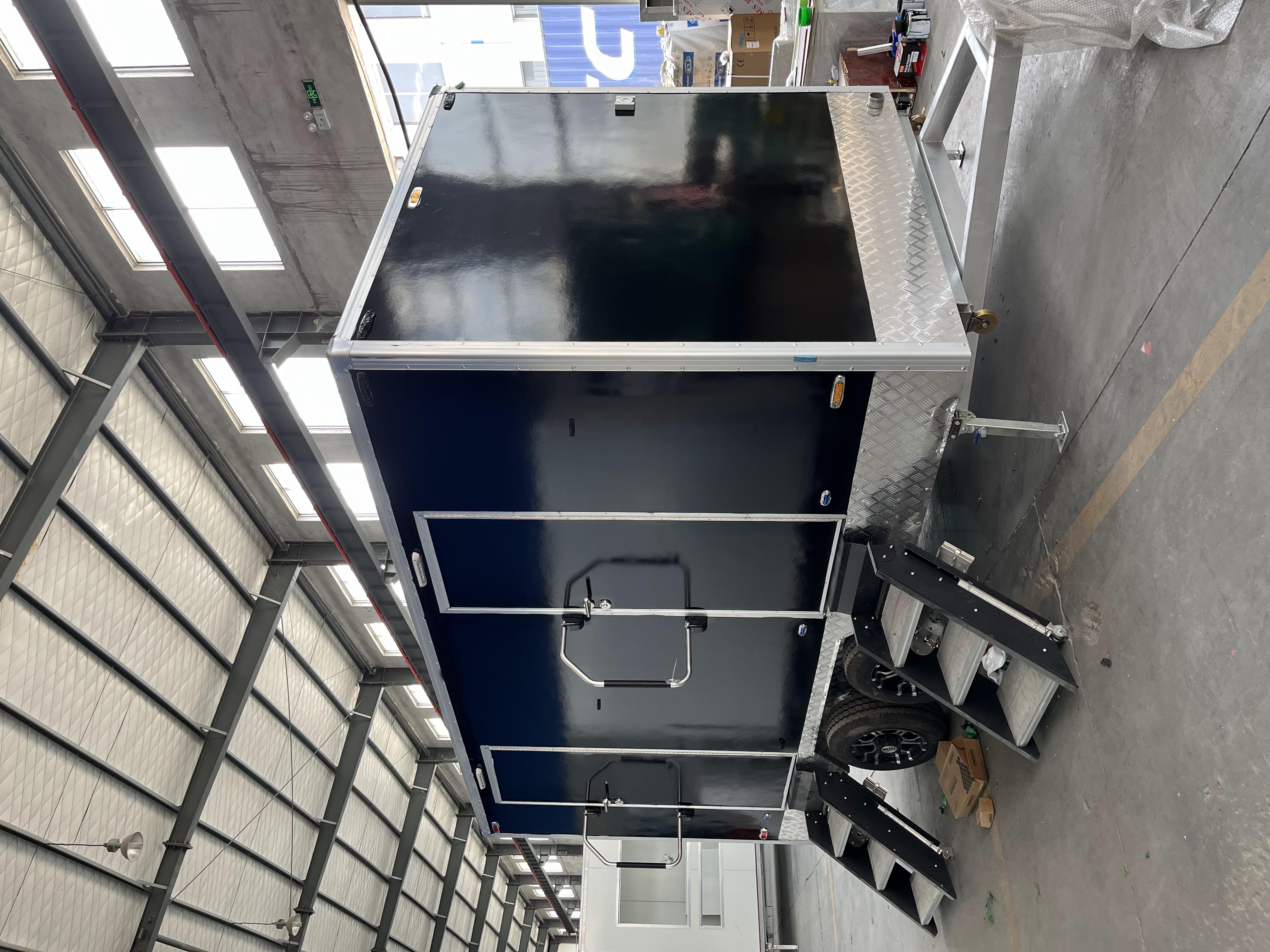 Black two-toilet portable toilet trailer
