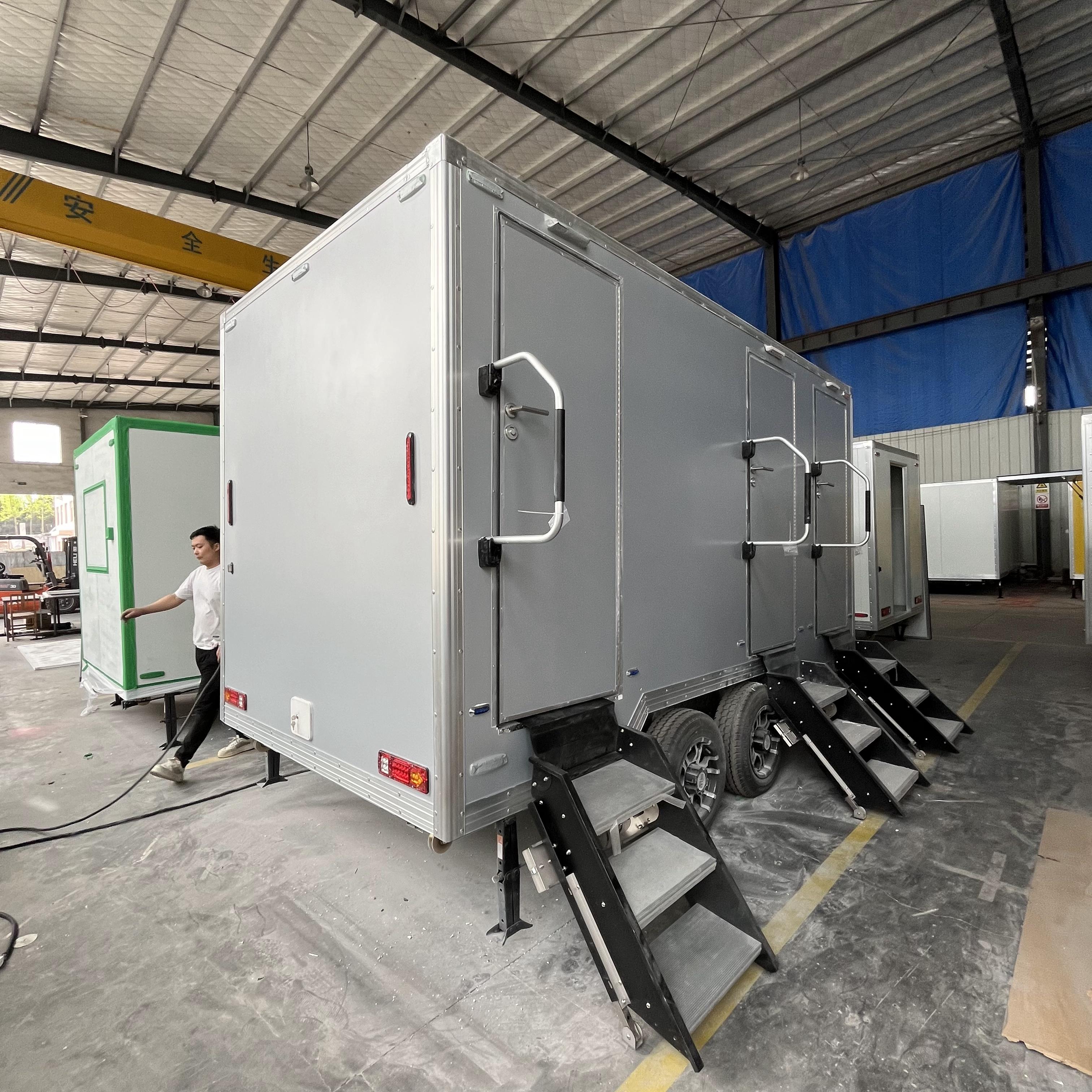 Grey movable three-toilet trailer