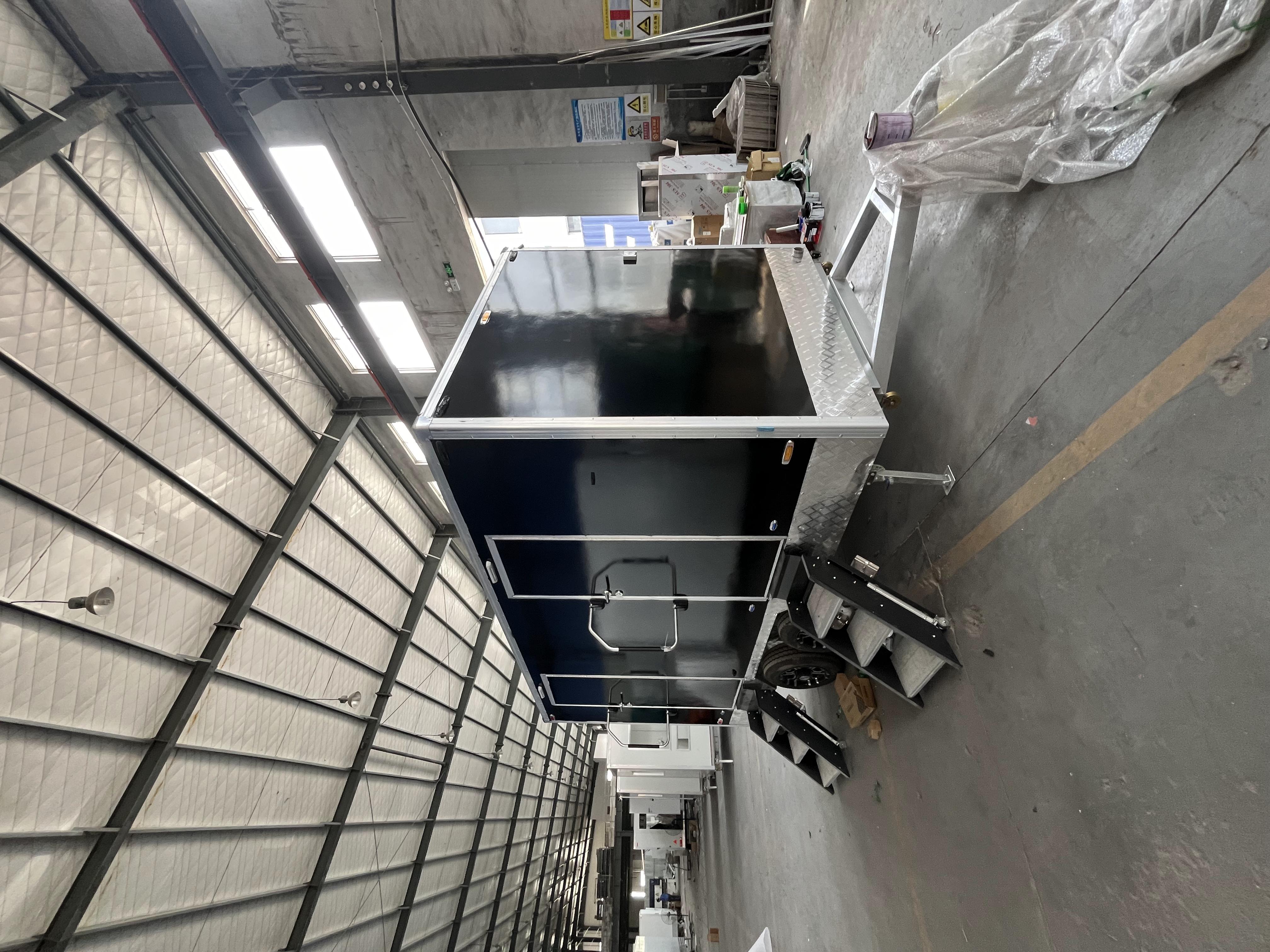 Black two-toilet portable toilet trailer