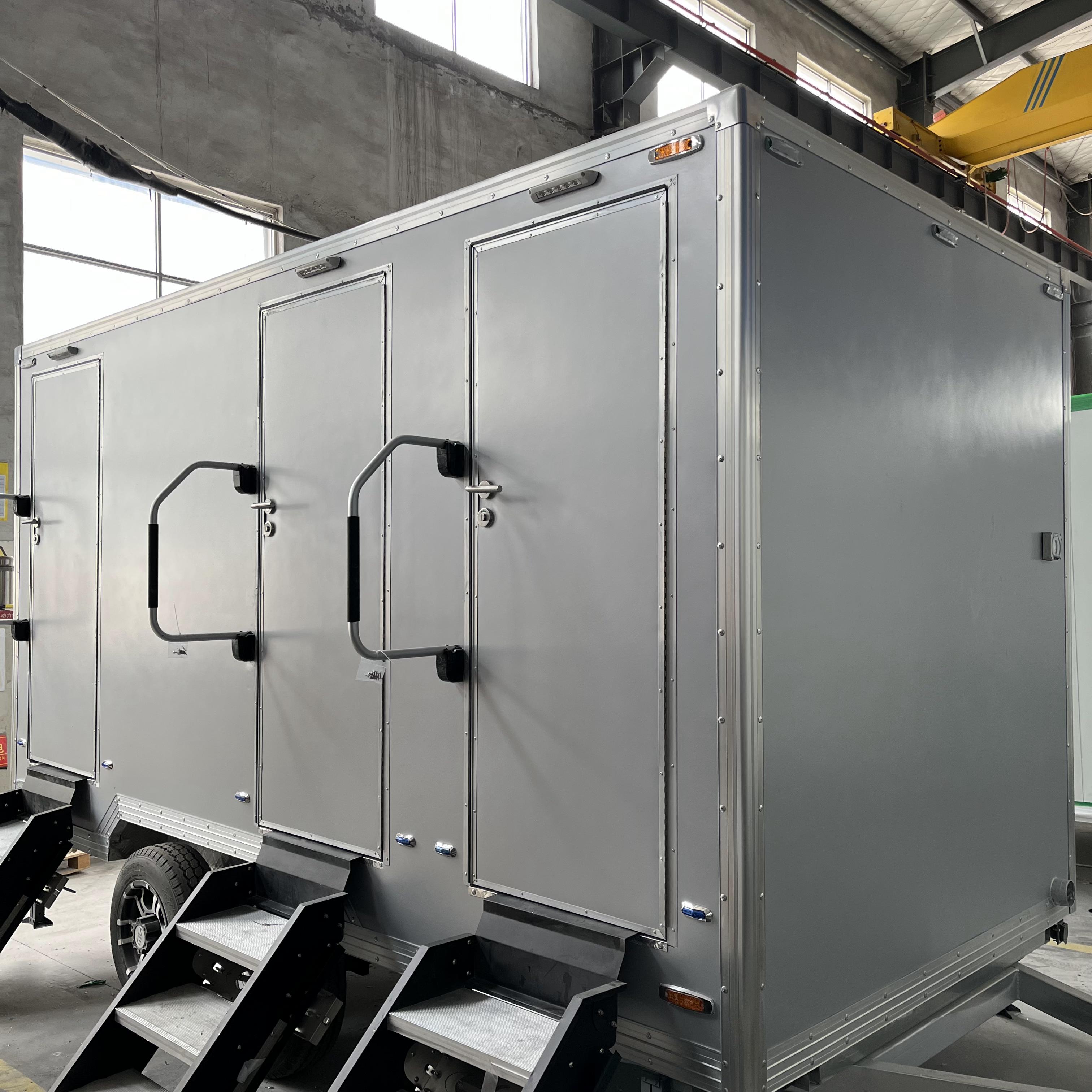 Grey movable three-toilet trailer
