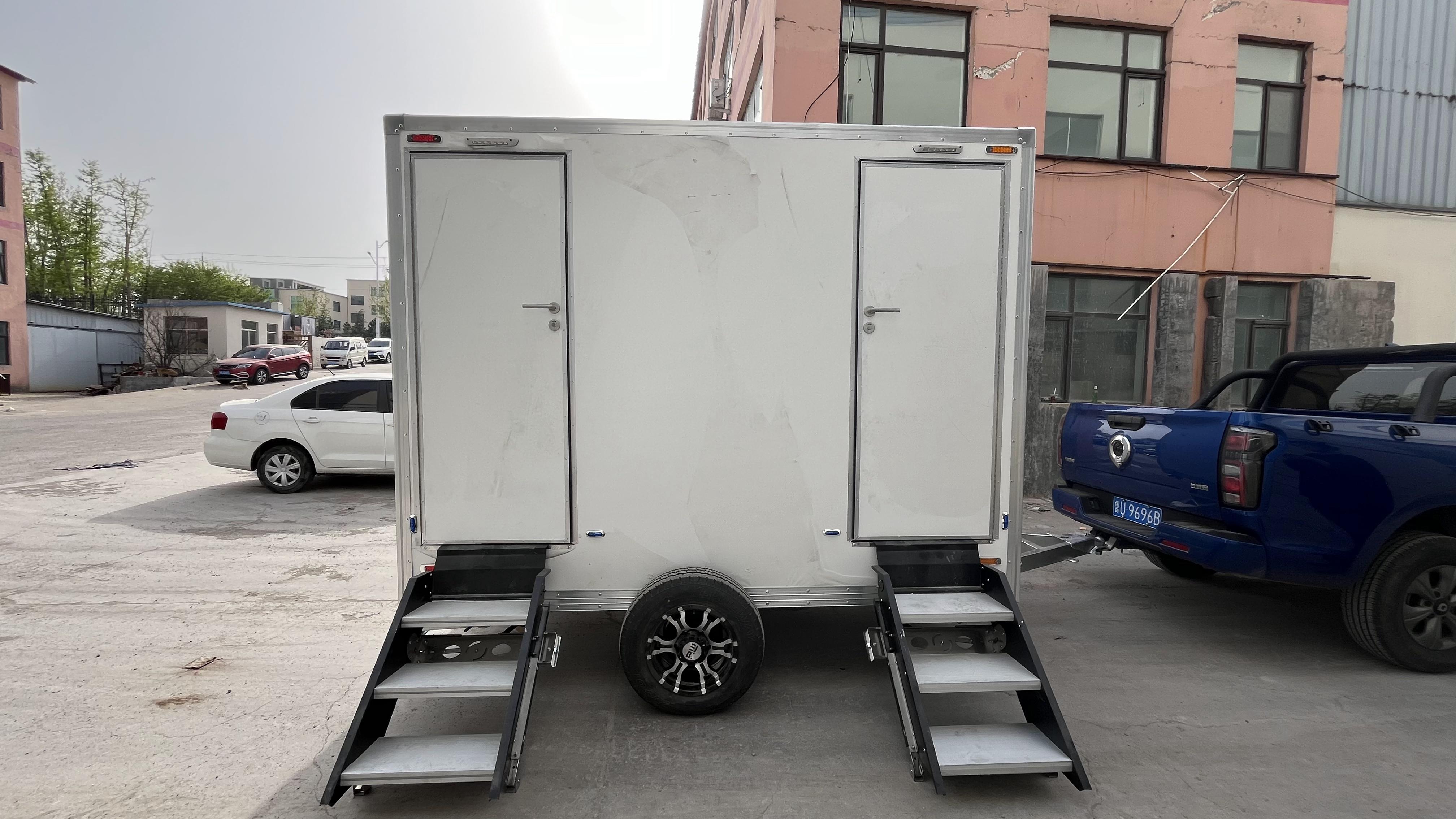 Two white portable toilet trailers: sturdy and durable, easy to move, creating a comfortable toilet experience.