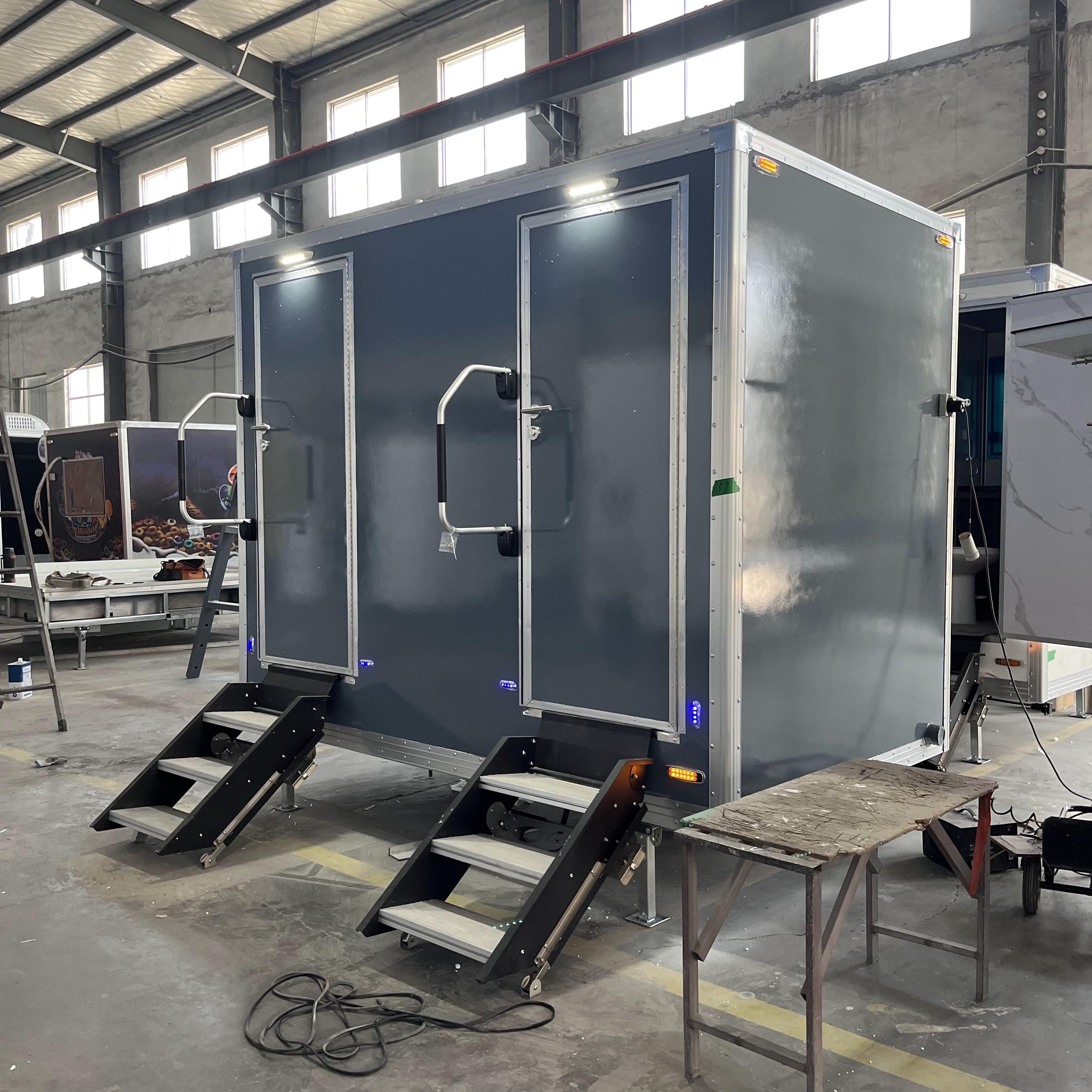 Mobile trailer with double toilet compartments and grey lightweight body