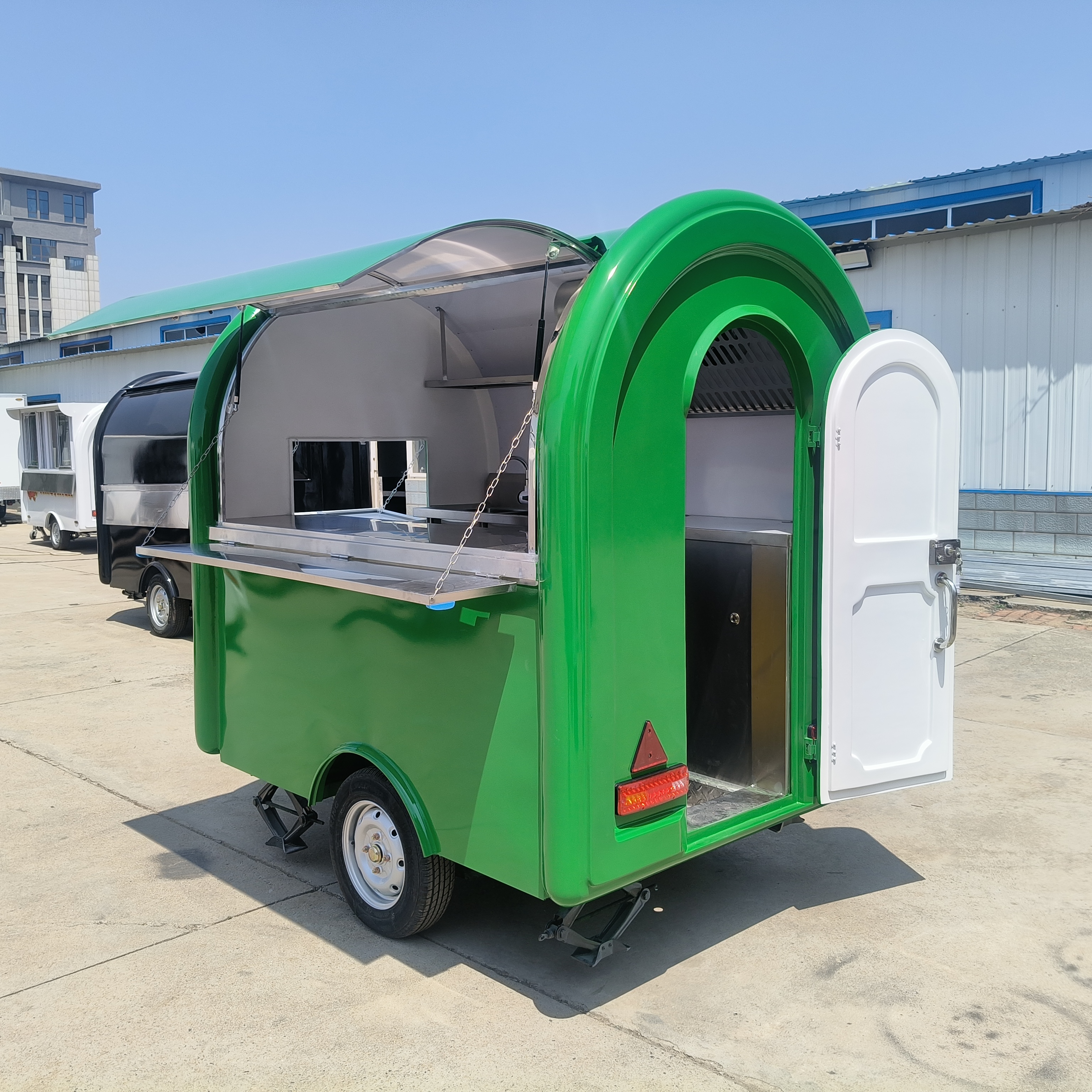 The green small towing food cart is convenient and mobile