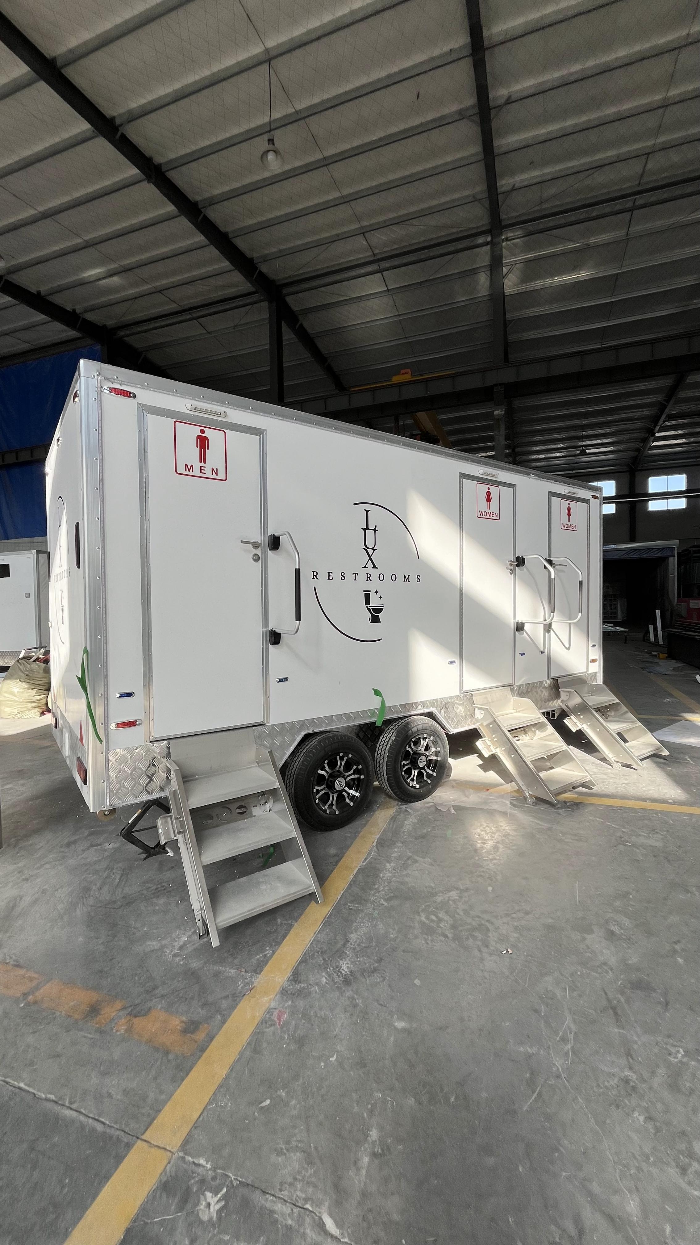 Three mobile toilet trailers with stickers, Instagram-style painted bathroom vehicles, commercial event check-in spots, and quick deployment in a towed manner