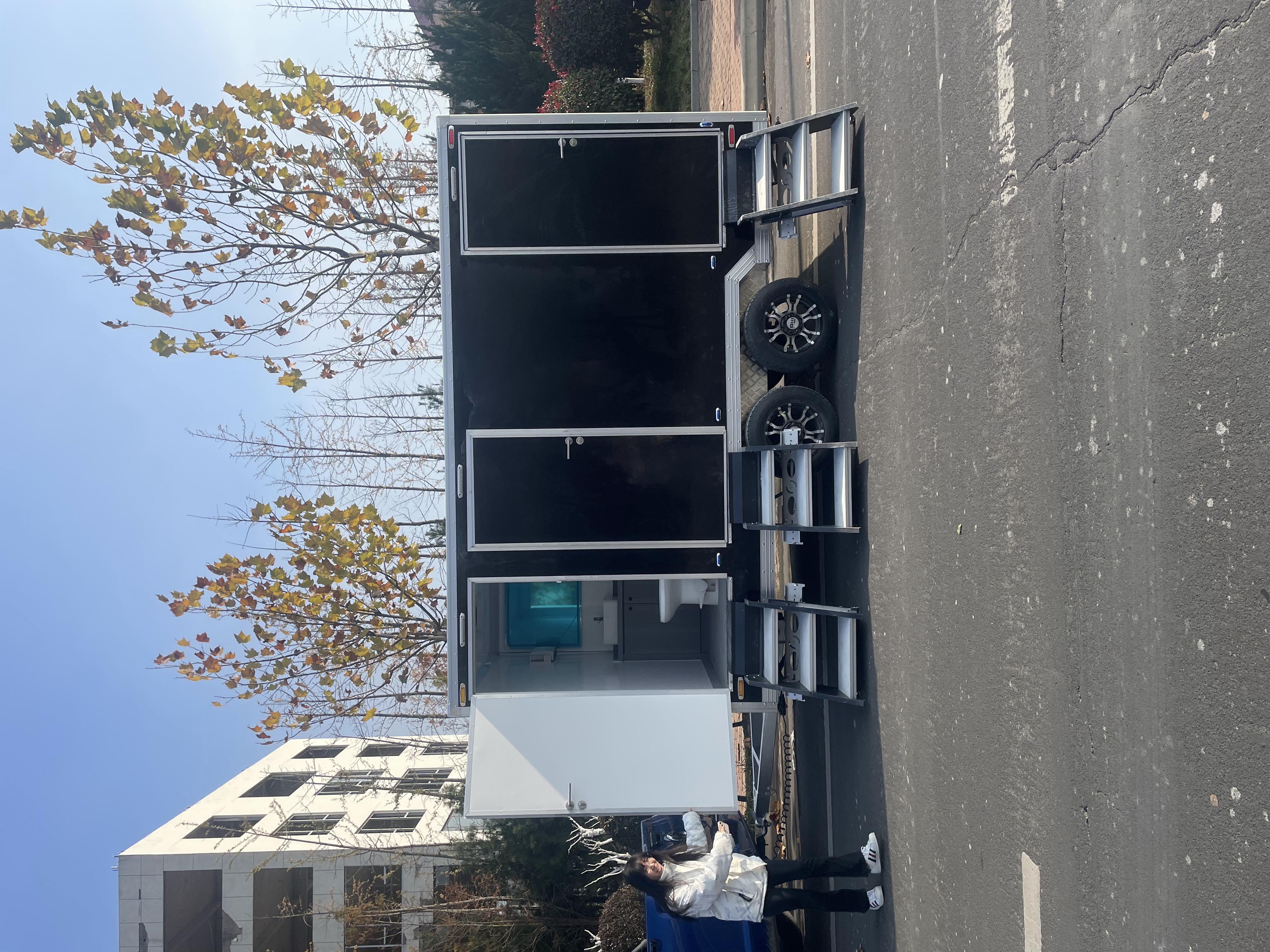 Black trailer-mounted mobile toilet, meeting the needs of various scenarios