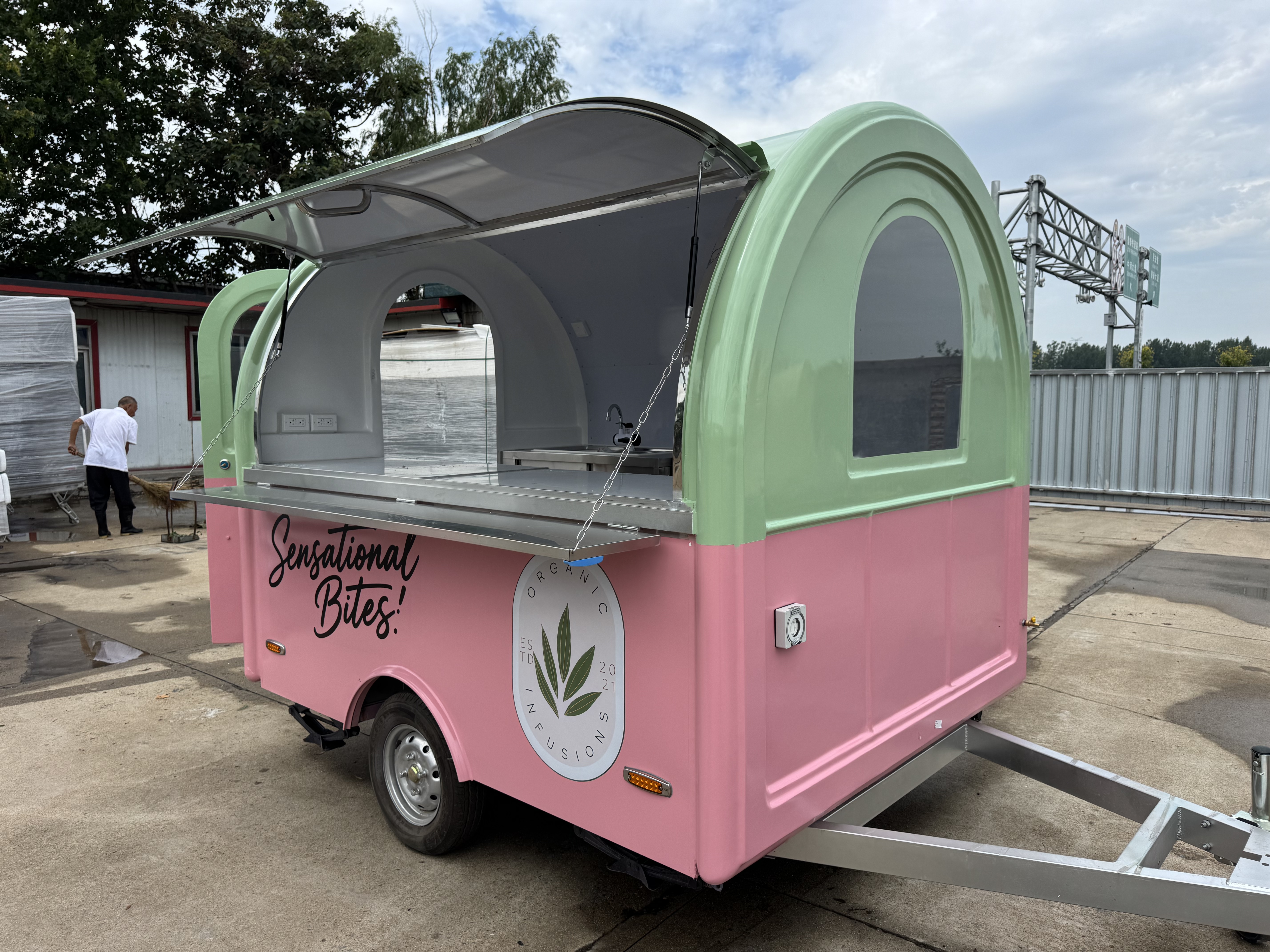 A mobile food truck with a combination of pink and green and colors, brimming with girlish charm