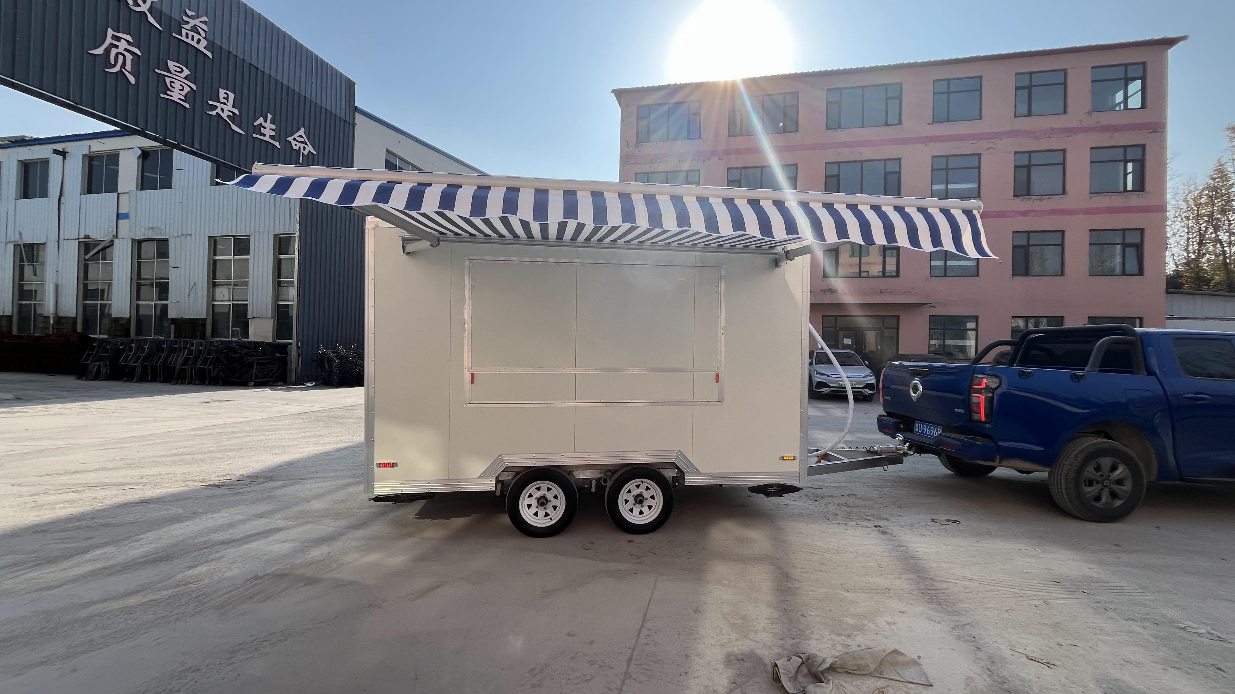 A mobile food truck with a sunshade, a towable mobile store for business start-up and stall setting, catering vehicle.