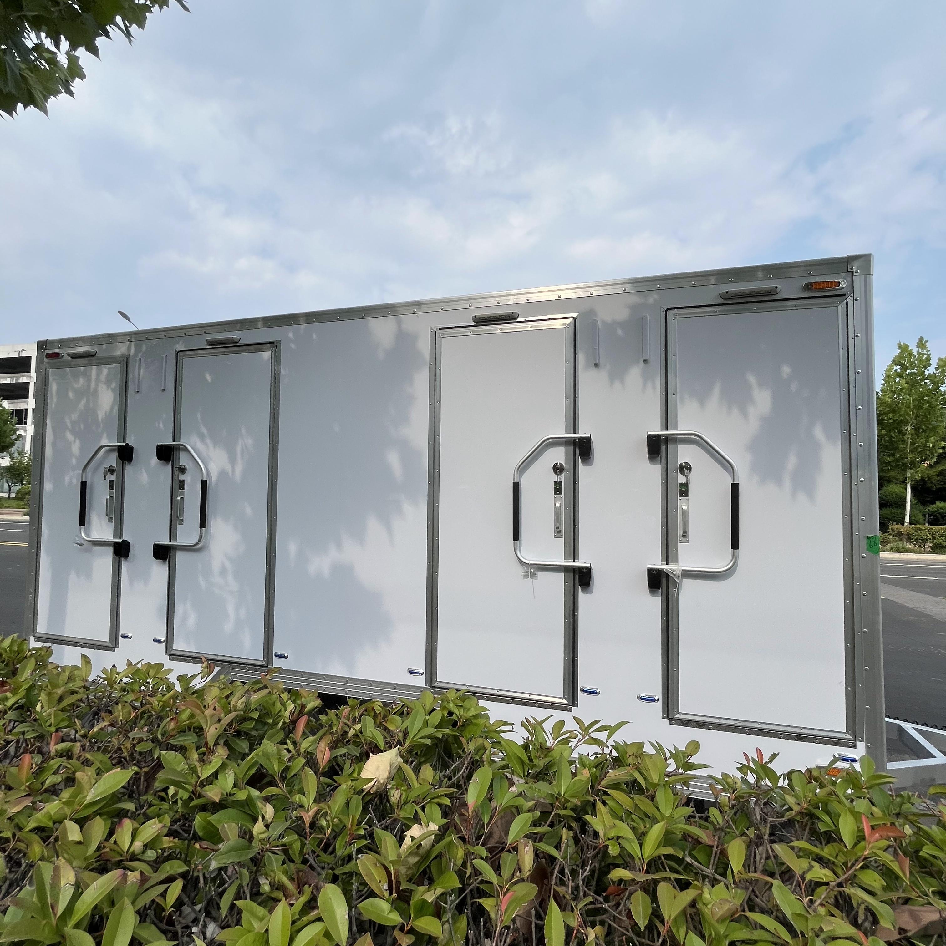 White trailer four-cabin outdoor mobile toilet facilities for multiple people