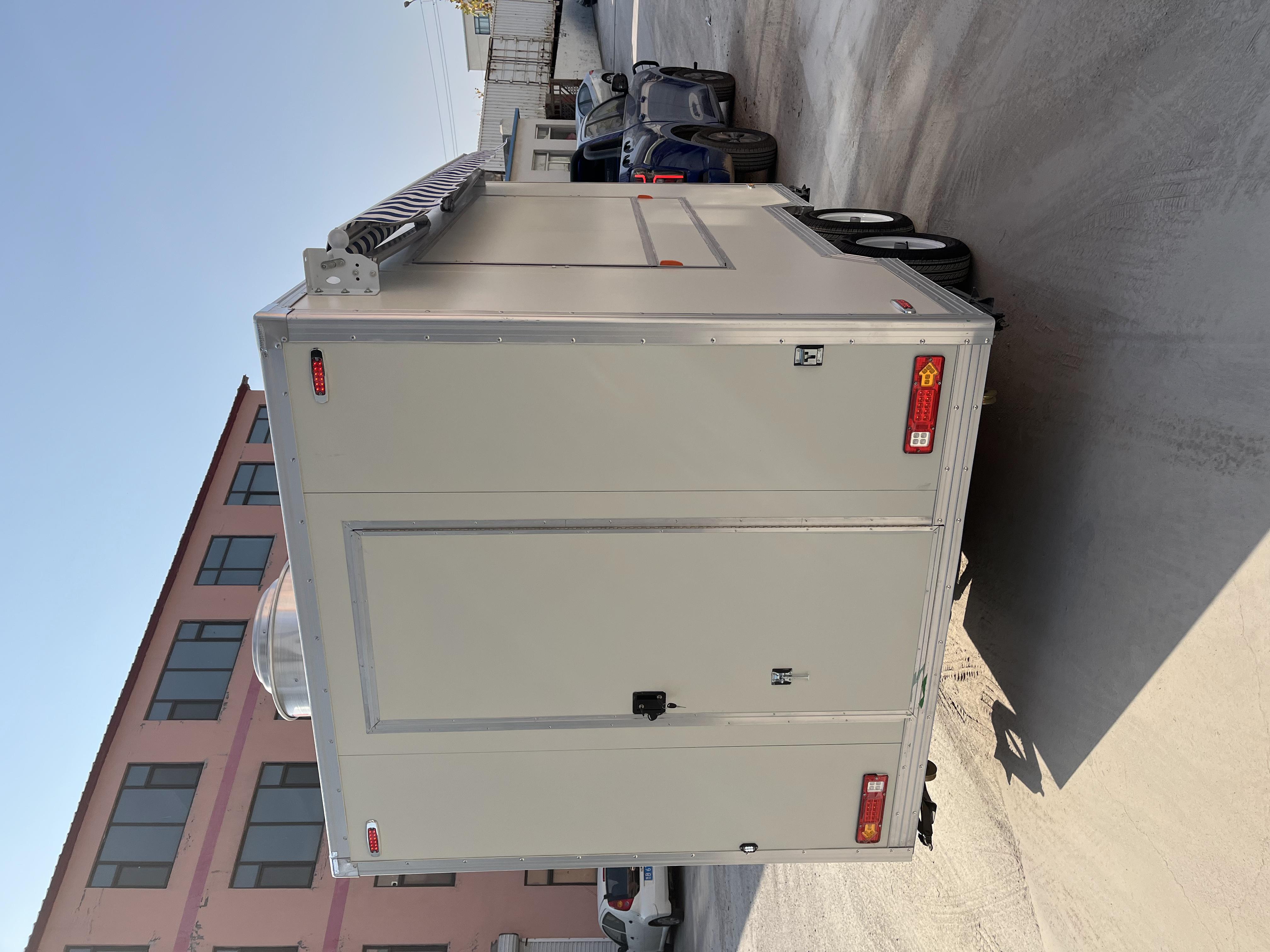 A mobile food truck with a sunshade, a towable mobile store for business start-up and stall setting, catering vehicle.