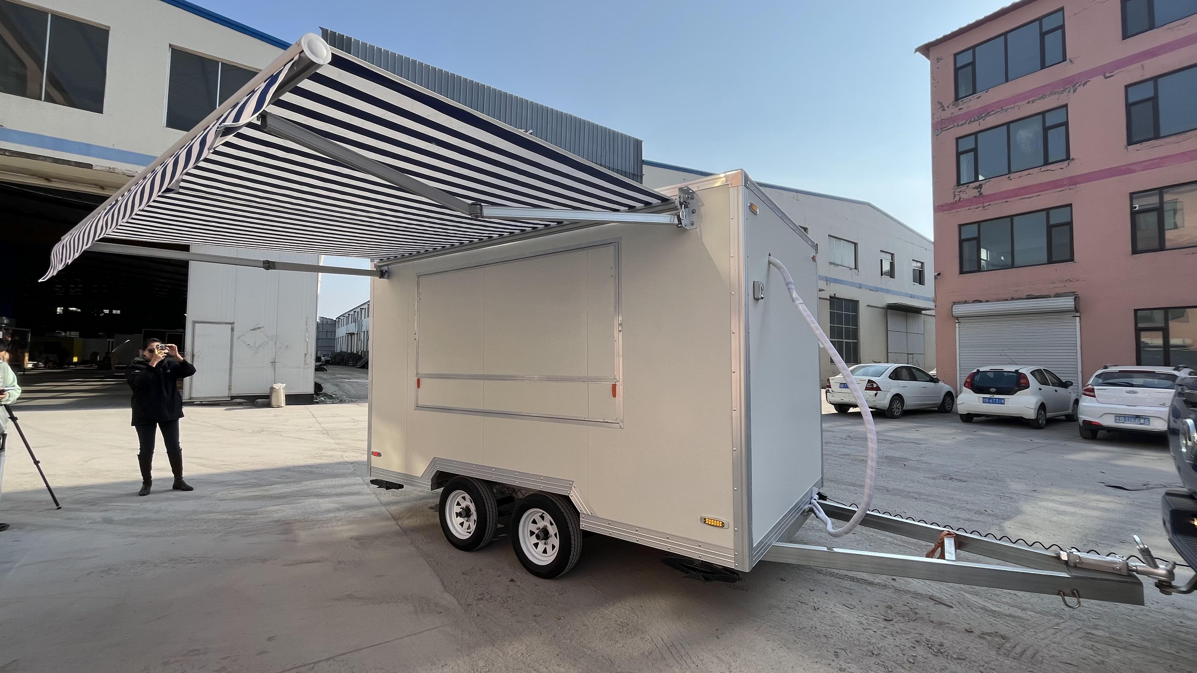 A mobile food truck with a sunshade, a towable mobile store for business start-up and stall setting, catering vehicle.