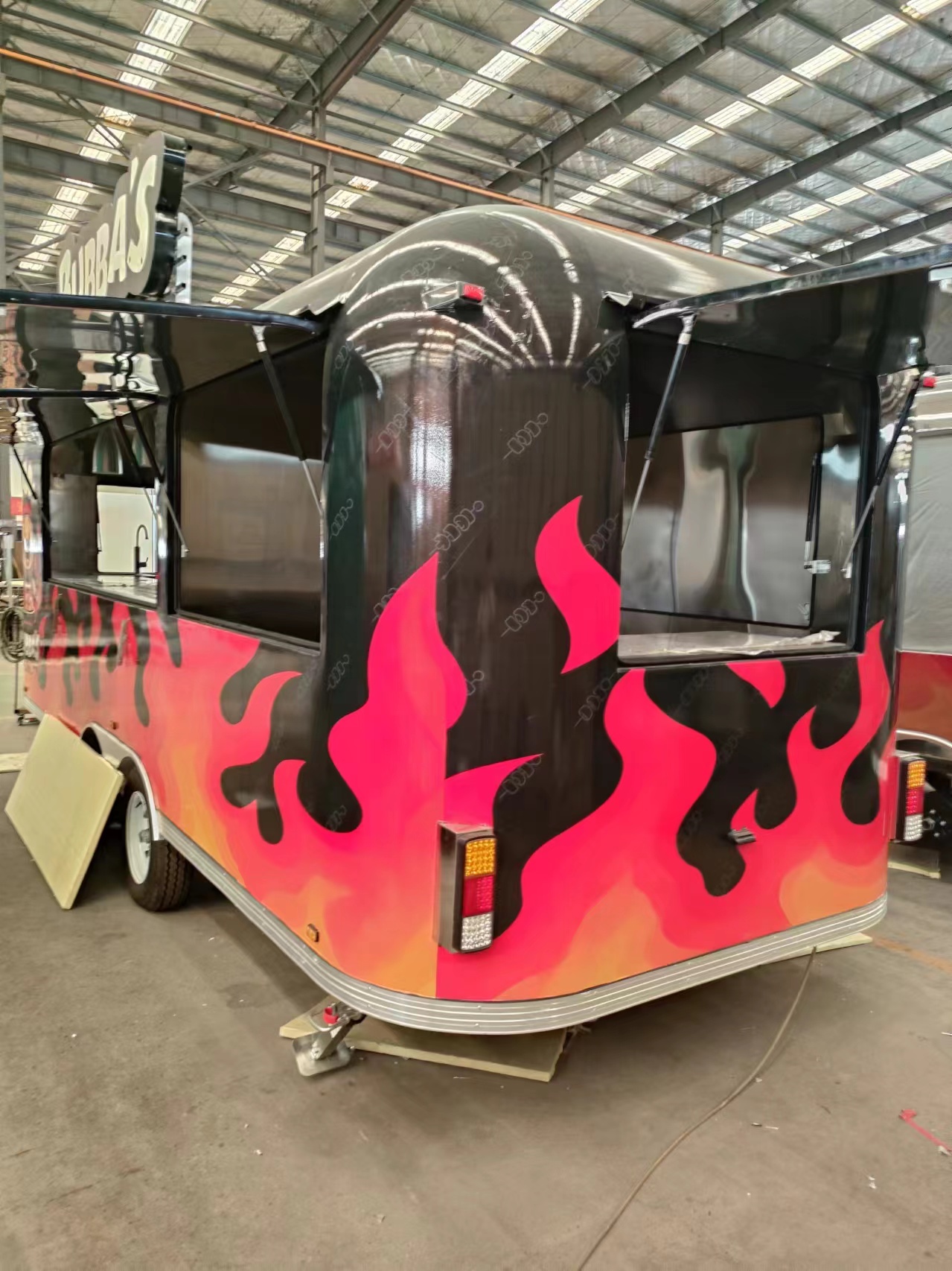The classic black and red color scheme with patterns food truck is a must-have for mobile shops
