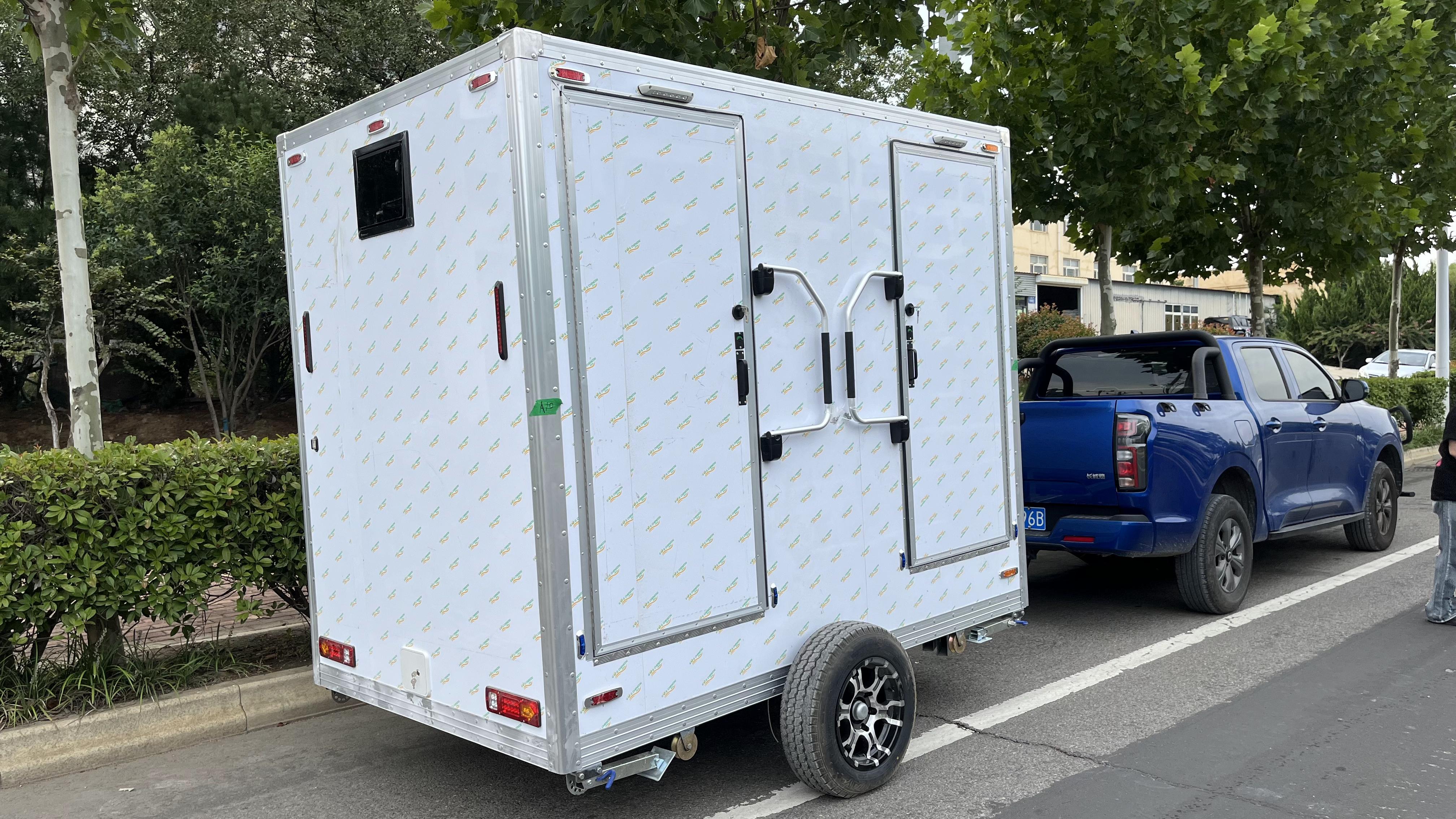 Trailer-mounted mobile double-door toilet for outdoor convenience