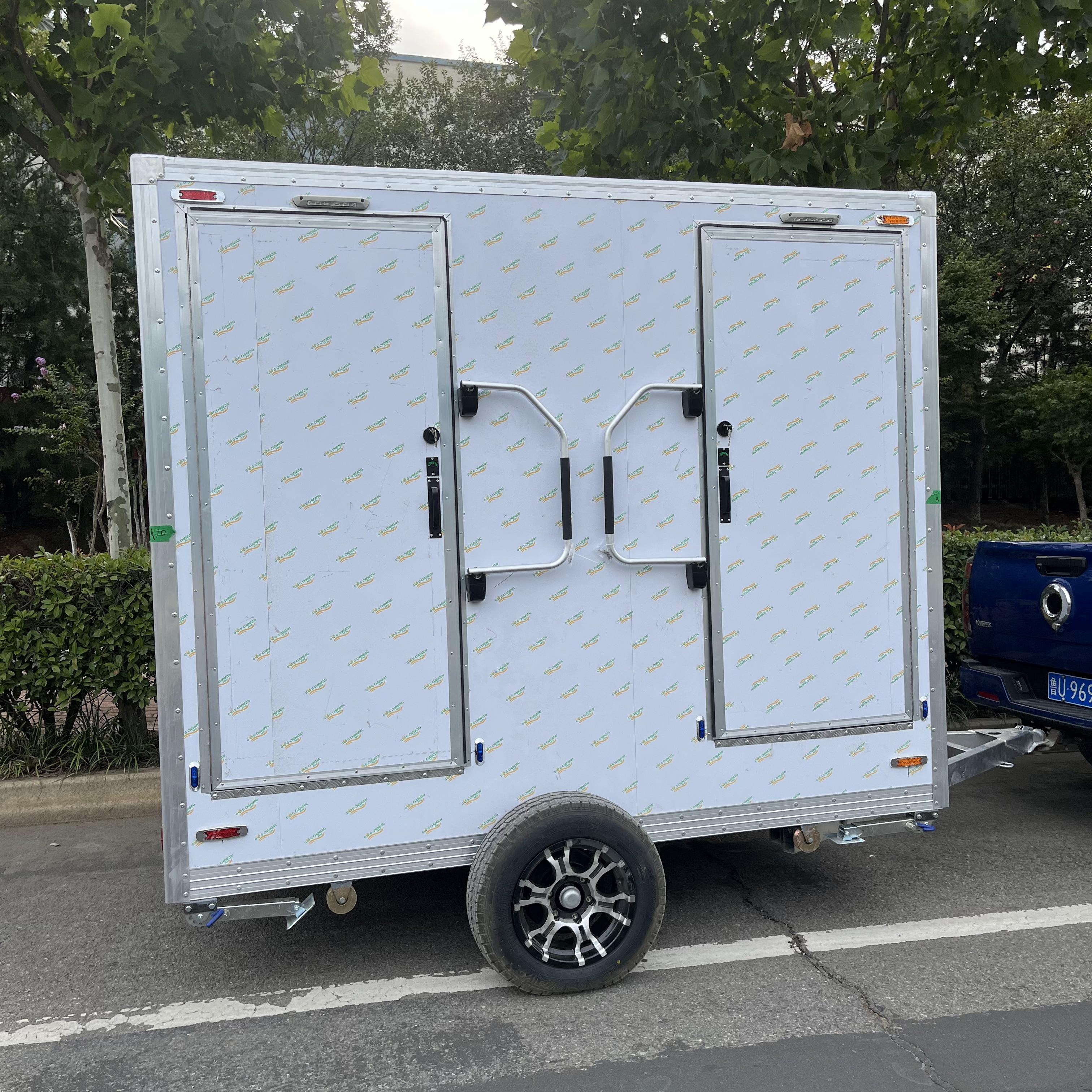 Trailer-mounted mobile double-door toilet for outdoor convenience