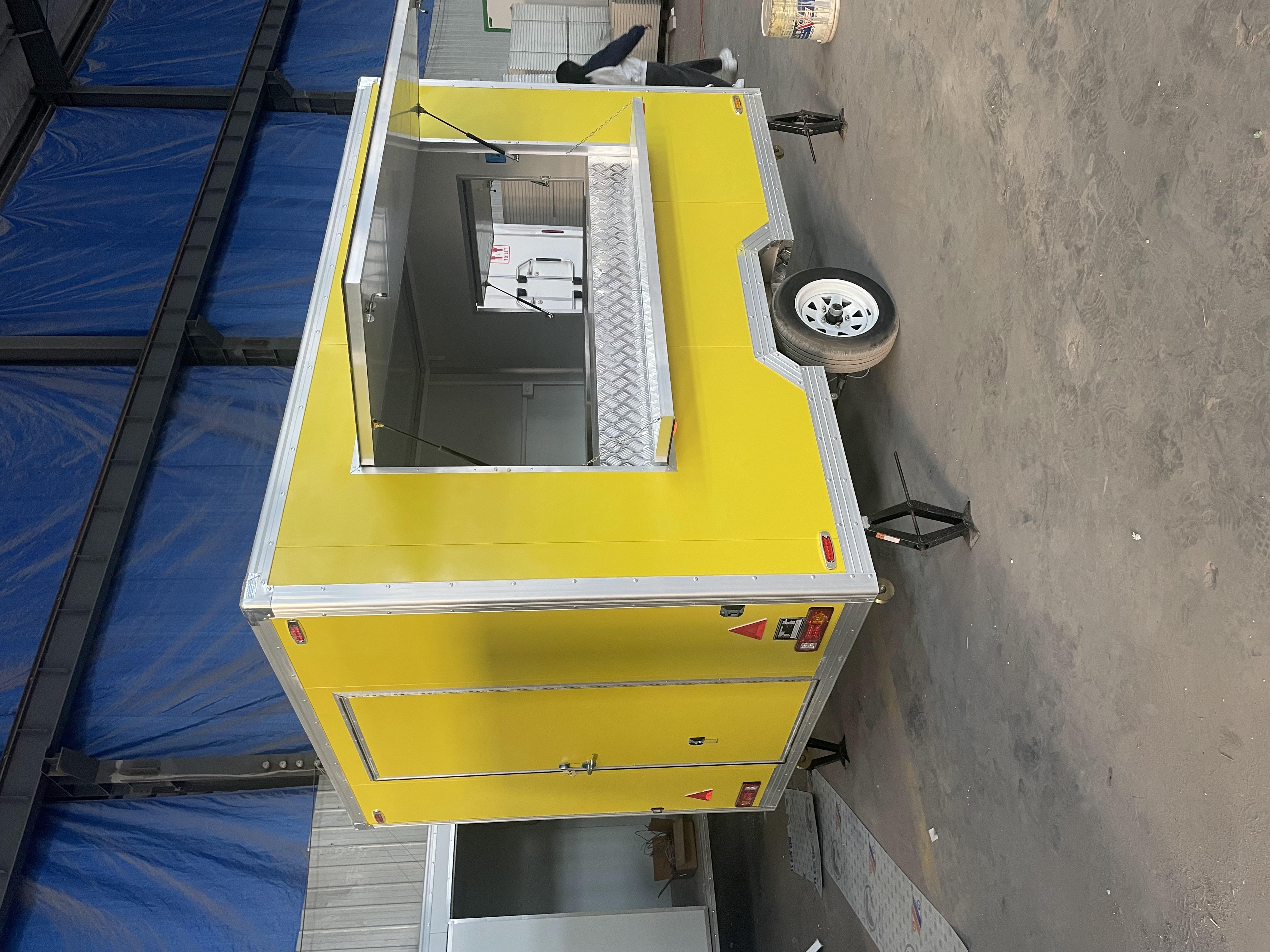 The bright yellow mobile food truck initiates a new flexible food business model