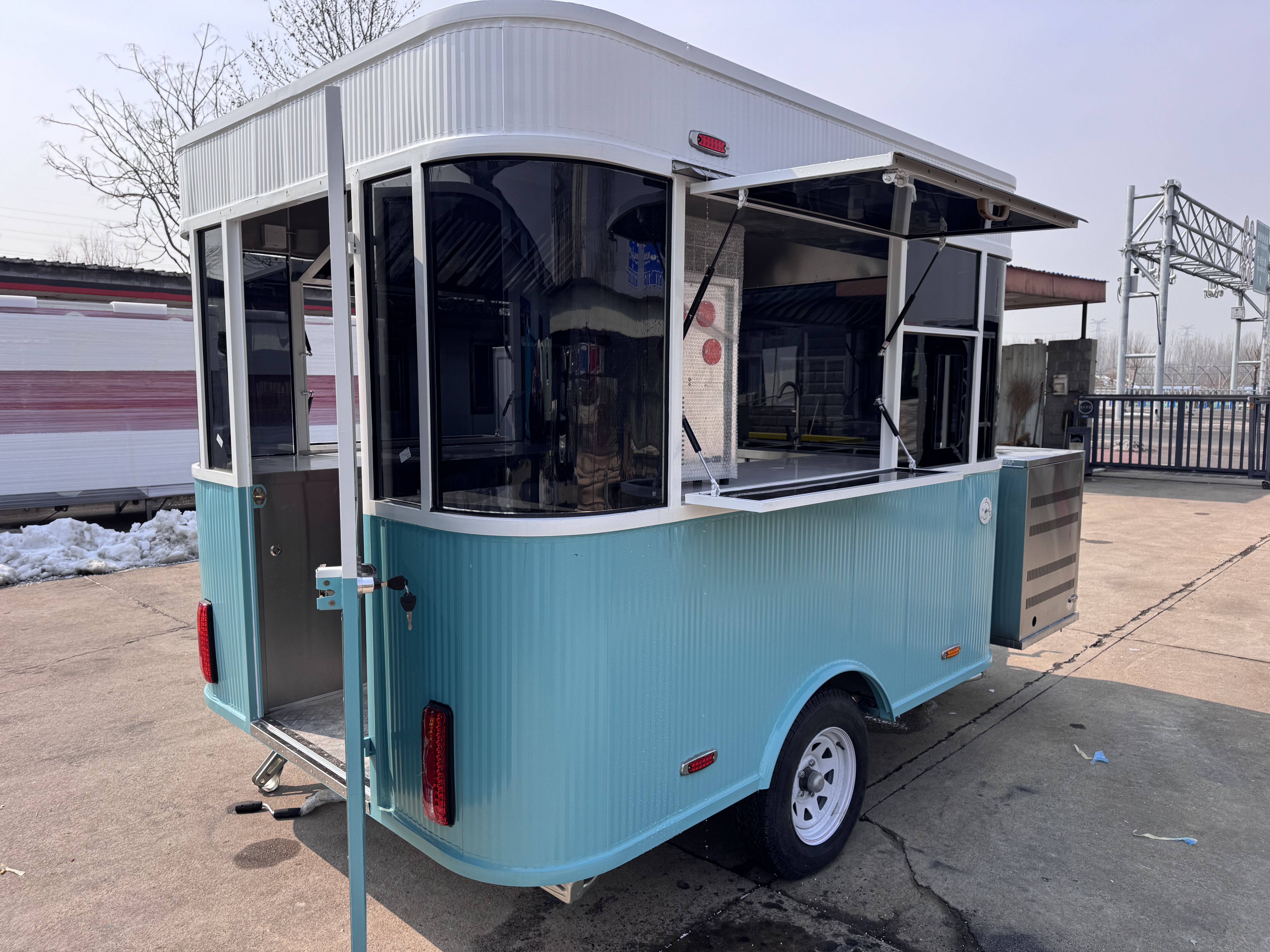 A fresh blue and white color mobile food truck for outdoor food sales