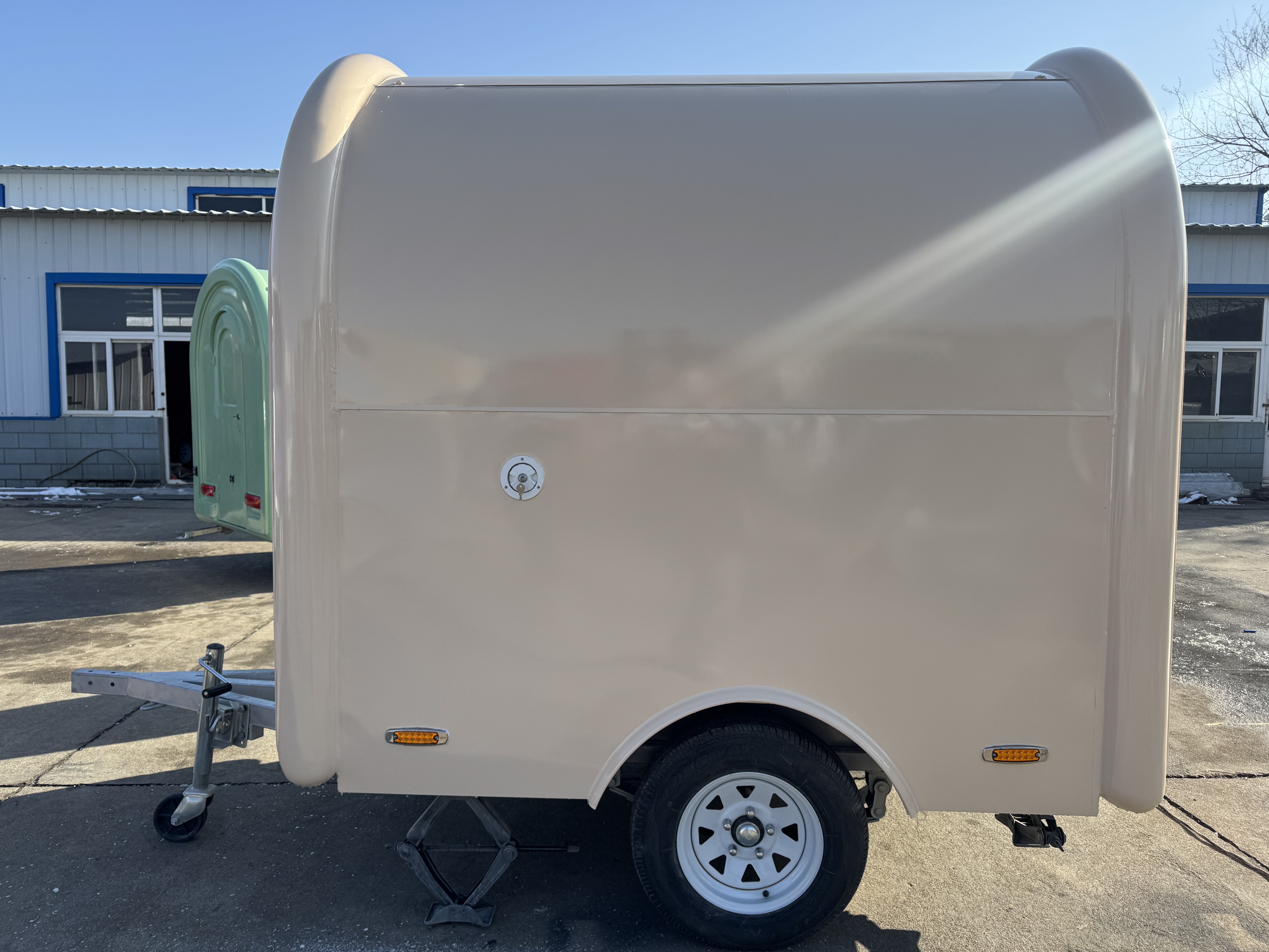 Cream-colored arc-shaped mobile food truck - a multi-functional mobile food truck for popular street food stalls